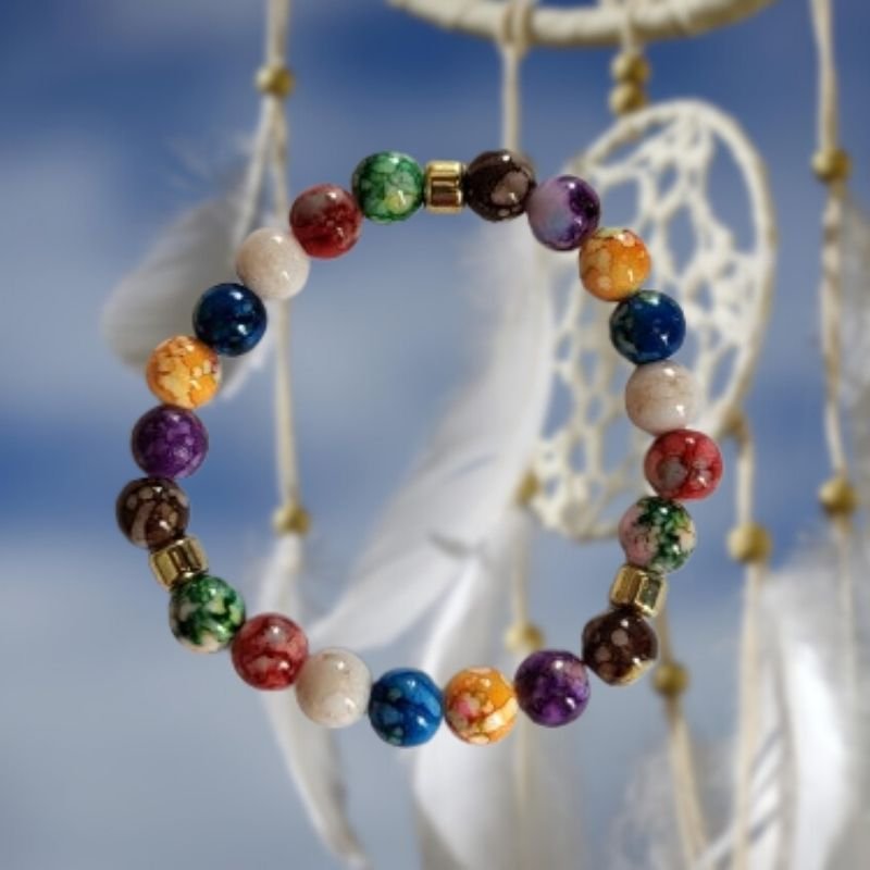 Bracelet des 7 chakras posé sur fond zen